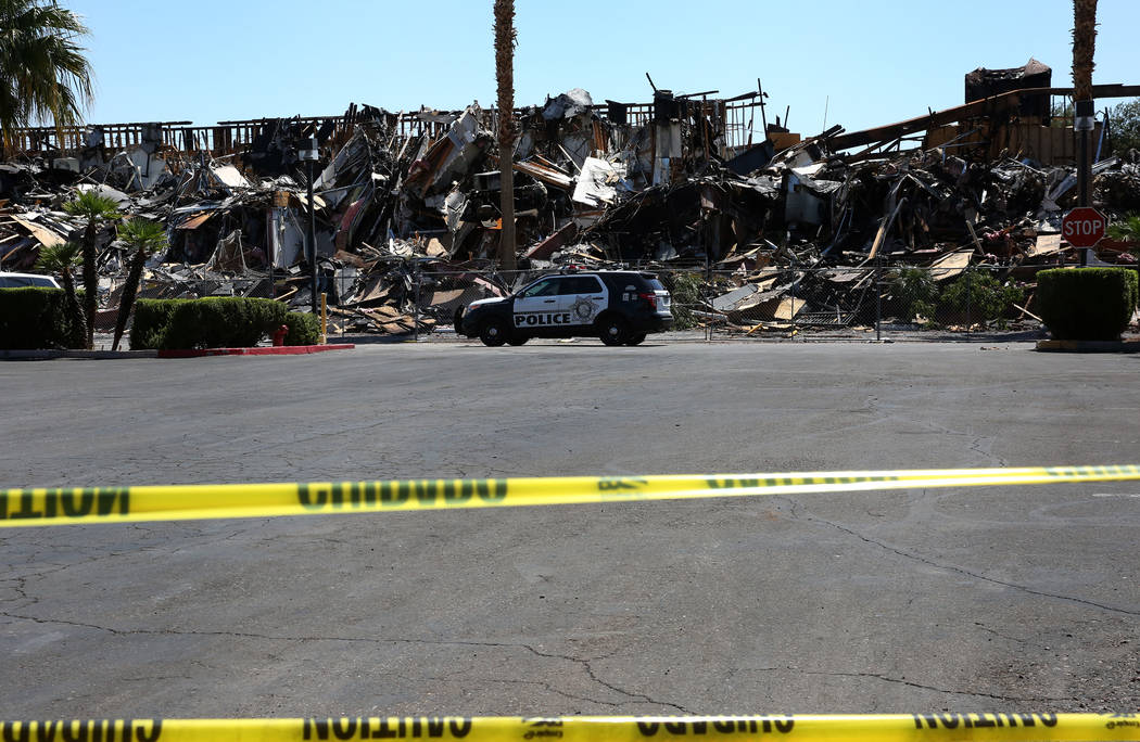 The rubble of burned-out office building at The Park at 3900 Paradise Road is blocked by cautio ...