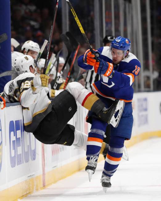 New York Islanders center Mathew Barzal (13) collides with Vegas Golden Knights left wing Tomas ...