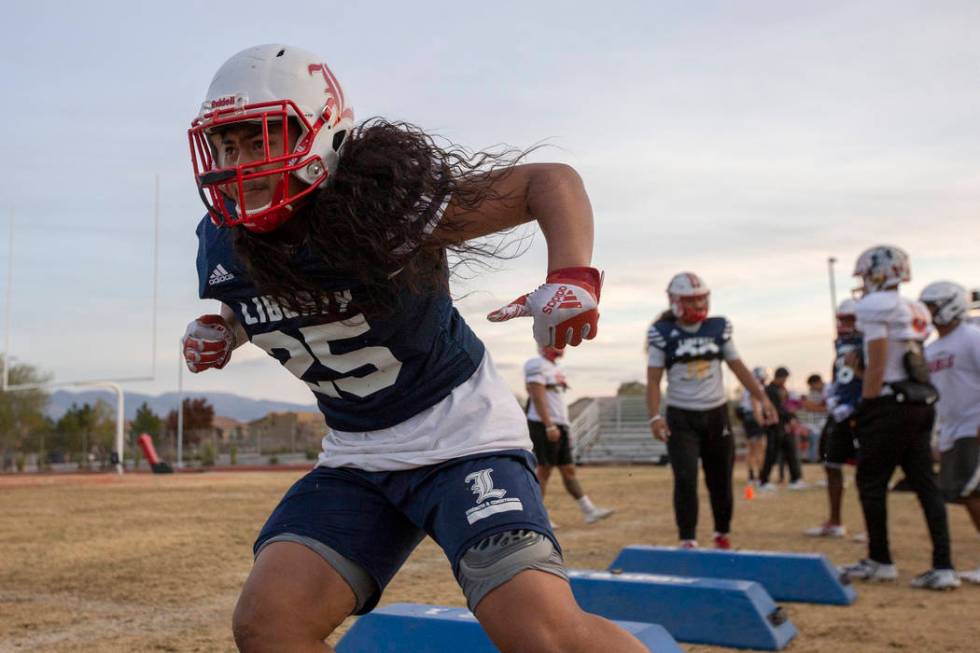 Liberty's inside linebacker Malachi Maika-Lepisi Asuega runs drills during football practice at ...