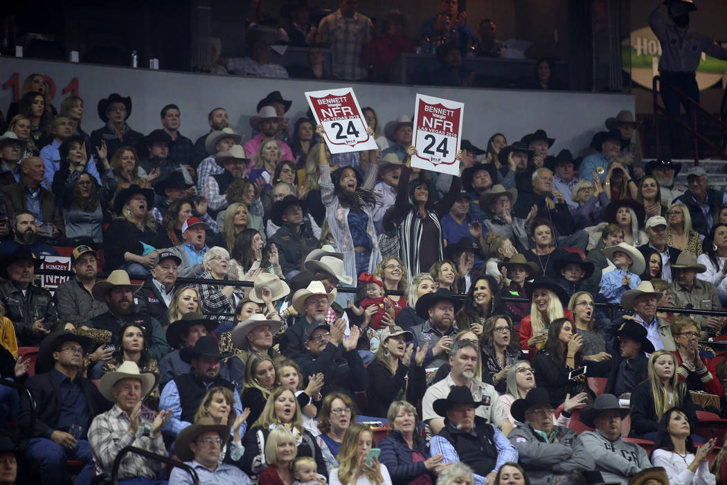 Fans of Caleb Bennett of Corvallis, Mont. cheer their rider in the Bareback Riding competition ...