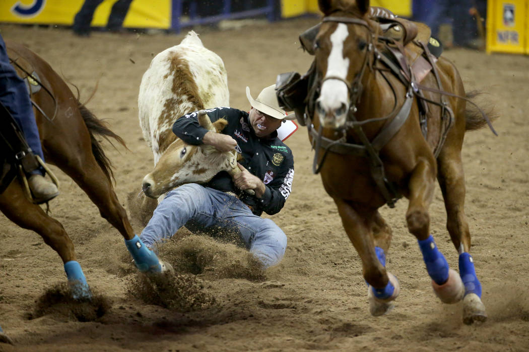 Matt Reeves of Cross Plains, Texas competes in the Steer Wrestling competition in the first go- ...