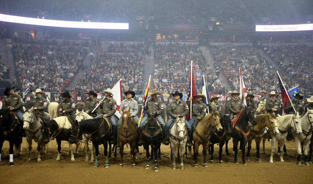 Competitors line up during the opening ceremony of the 10-day Wrangler National Finals Rodeo at ...