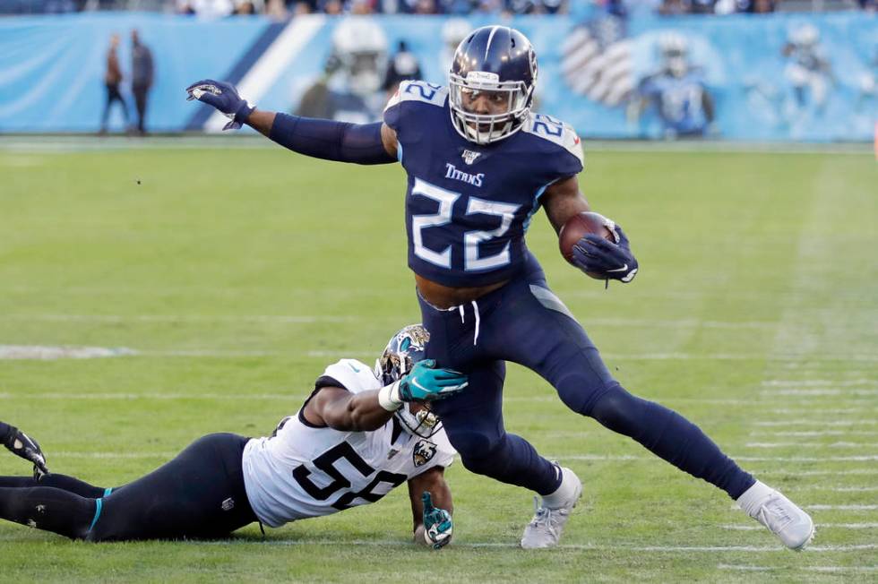 Tennessee Titans running back Derrick Henry (22) gets past Jacksonville Jaguars linebacker Quin ...