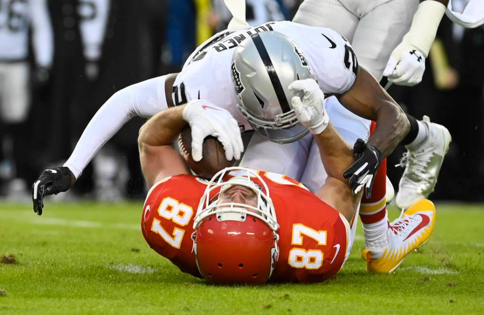 Oakland Raiders free safety Lamarcus Joyner (29) tackles Kansas City Chiefs tight end Travis Ke ...