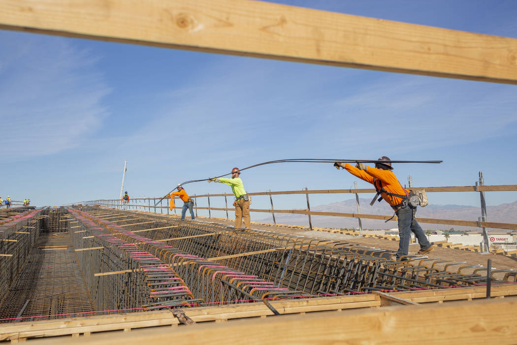 Construction workers install rebar on the Centennial Bridge connecting U.S. Highway 95 northbou ...