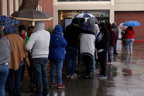 People line up to enter JCPenny at Meadows Mall in Las Vegas for early Black Friday deals on Th ...