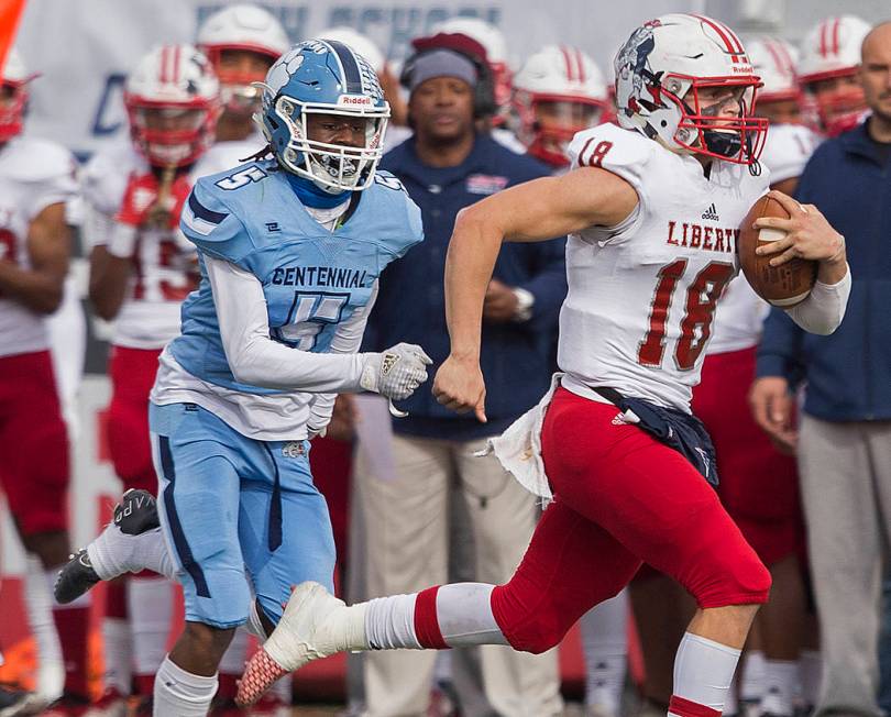 Liberty junior quarterback Daniel Britt (18) breaks a big run down the sideline past Centennial ...