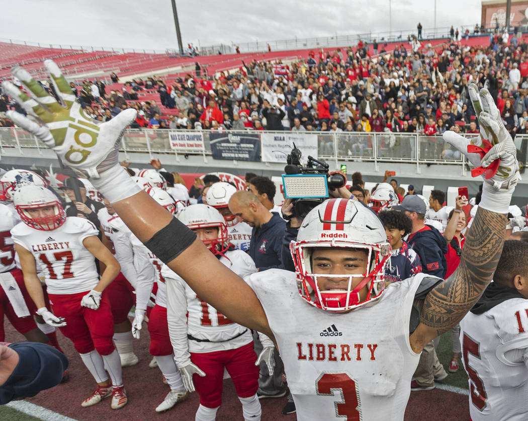 Liberty junior linebacker Zephania Maea (3) celebrates after defeating Centennial 50-7 to win t ...