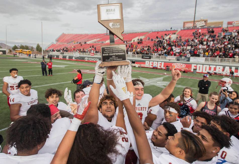 Liberty players celebrate after defeating Centennial 50-7 to win the Class 4A state football ch ...