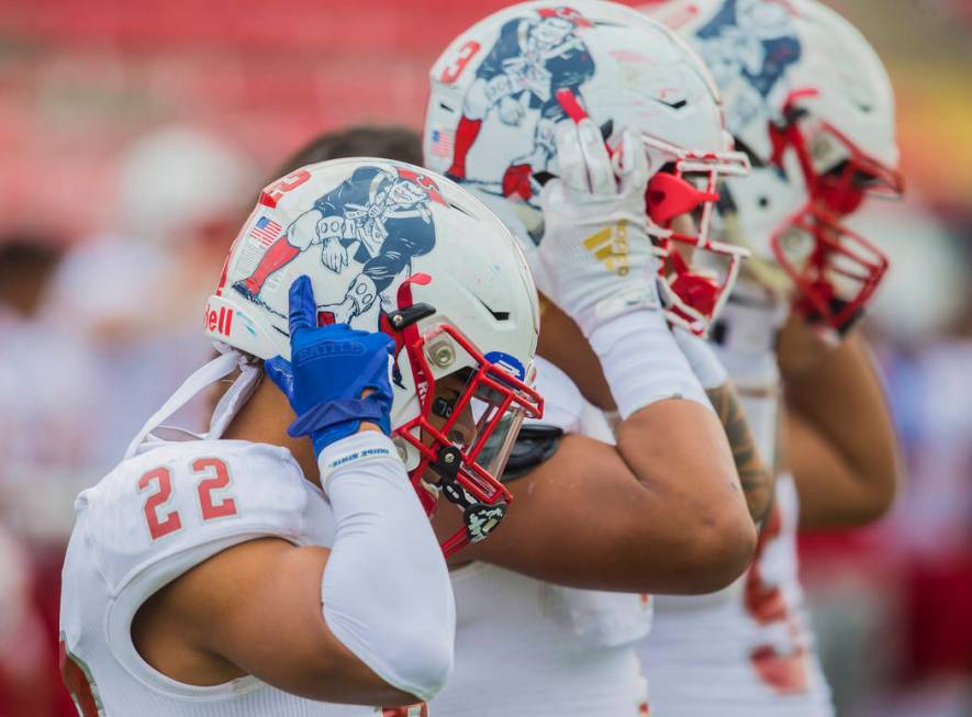 Liberty senior safety Trey Cain (22) straps on his helmet before the start of the Patriots Clas ...