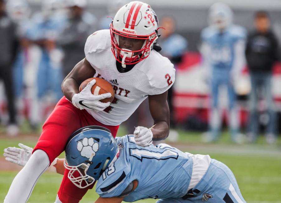 Liberty sophomore wide receiver Germie Bernard (2) drives towards the end zone over Centennial ...