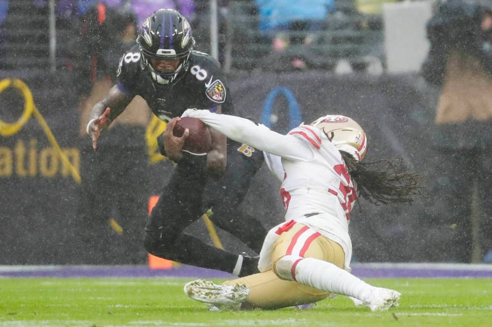 San Francisco 49ers defensive back Marcell Harris (36) strips the ball from Baltimore Ravens qu ...