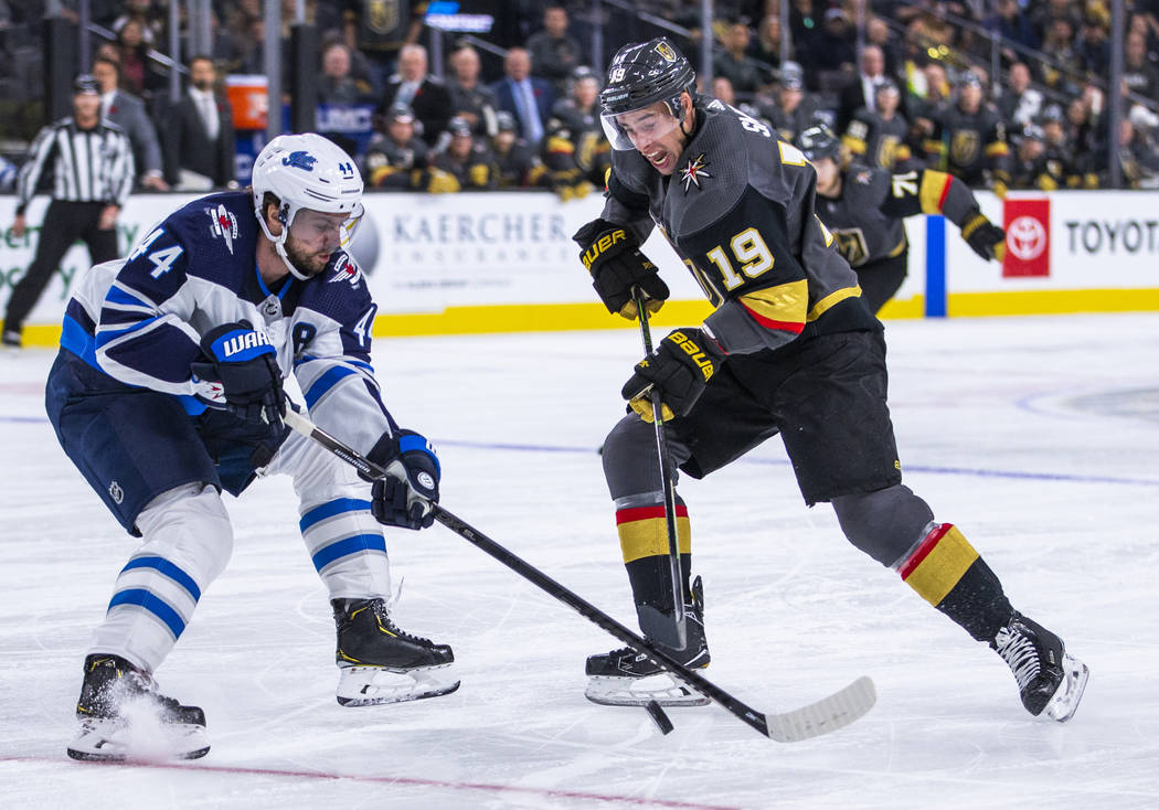 Vegas Golden Knights right wing Reilly Smith (19) looks to shoot past Winnipeg Jets defenseman ...