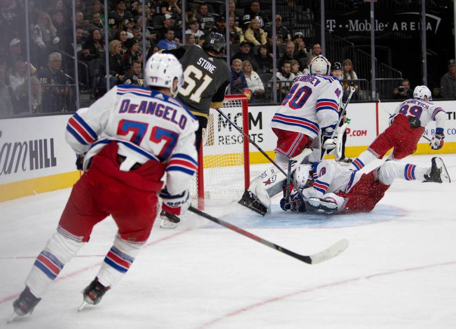 New York Rangers defenseman Jacob Trouba (8) slides into New York Rangers goaltender Alexandar ...