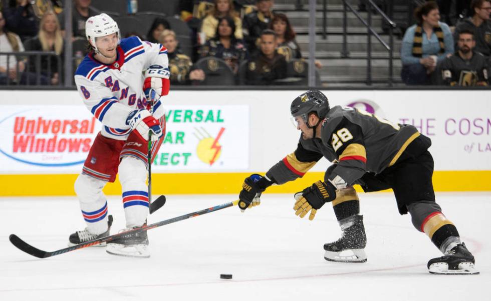 Golden Knights left wing William Carrier (28) reaches to take control of the puck as New York R ...