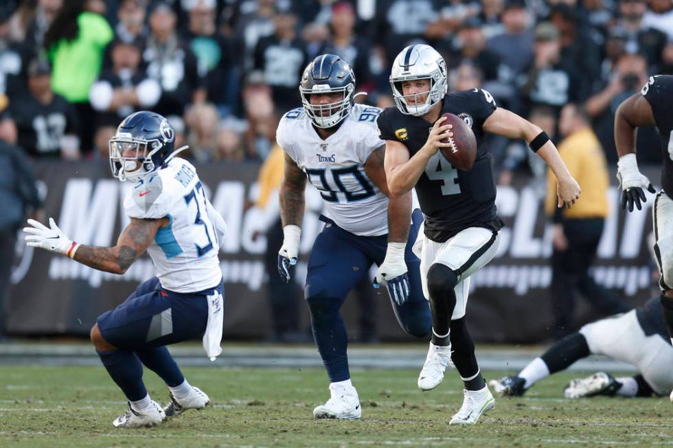 Oakland Raiders quarterback Derek Carr (4) runs against the Tennessee Titans during the second ...