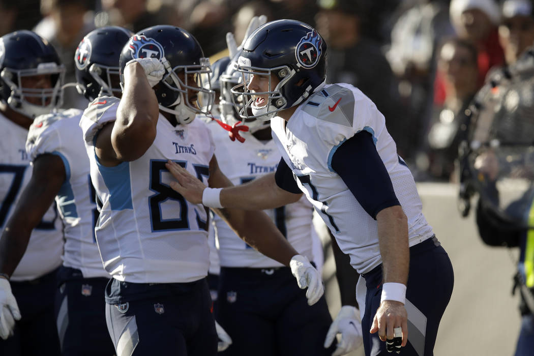Tennessee Titans quarterback Ryan Tannehill, right, celebrates with teammates after wide receiv ...