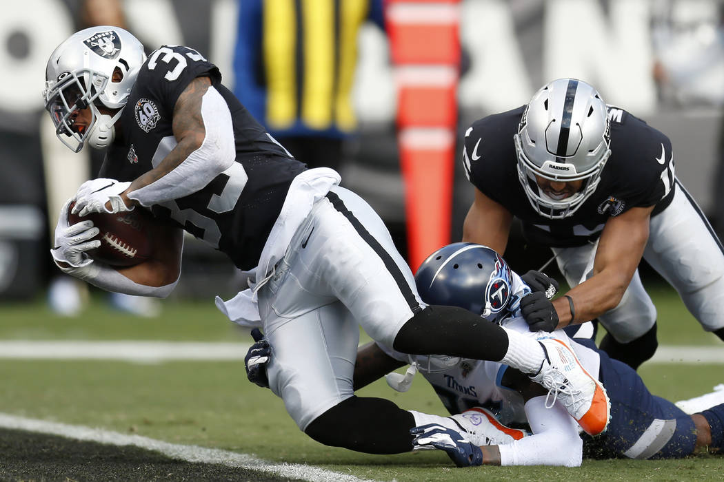 Oakland Raiders running back DeAndre Washington (33) scores a touchdown past Tennessee Titans d ...