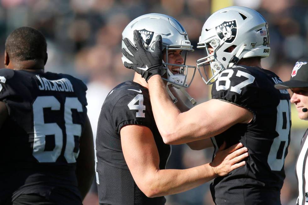 Oakland Raiders quarterback Derek Carr (4) celebrates with tight end Foster Moreau (87) after a ...