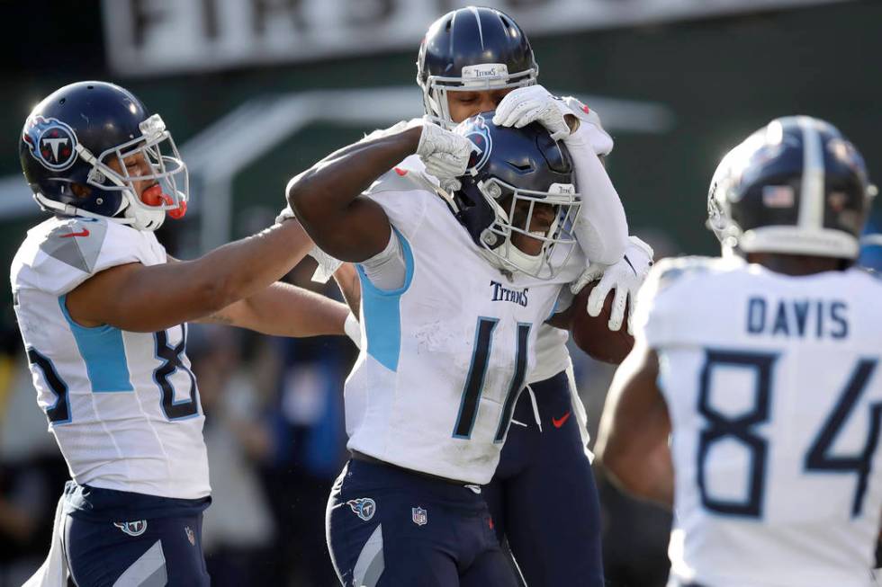 Tennessee Titans wide receiver A.J. Brown (11) is congratulated by teammates after scoring agai ...