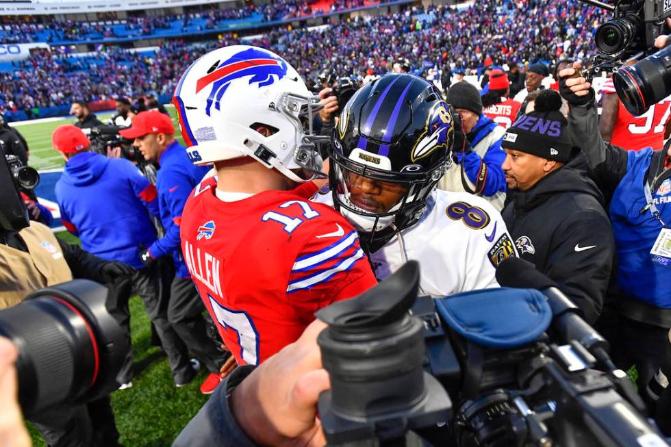 Baltimore Ravens quarterback Lamar Jackson (8) talks with Buffalo Bills quarterback Josh Allen ...