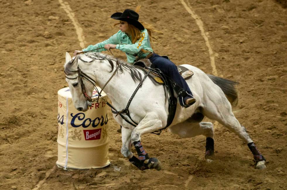 Emily Miller of Weatherford, Okla., turns the corner on her way to a time of 13.64 seconds and ...