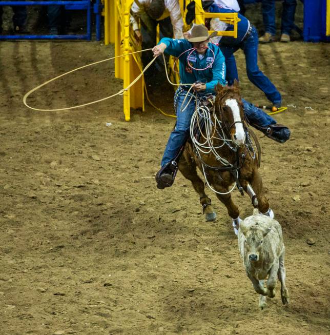 Tuf Cooper of Decatur, Texas, bears down on his calf in Tie-Down Roping during the fourth go ro ...