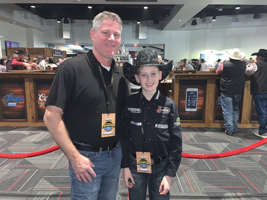 Seth Permenter, with his father Lance Permenter at the Golden Circle of Champions event Sunday, ...
