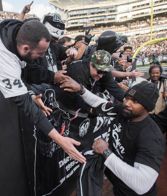 Oakland Raiders NFL Hall of Fame player Charles Woodson shakes hands with fans in the fourth qu ...