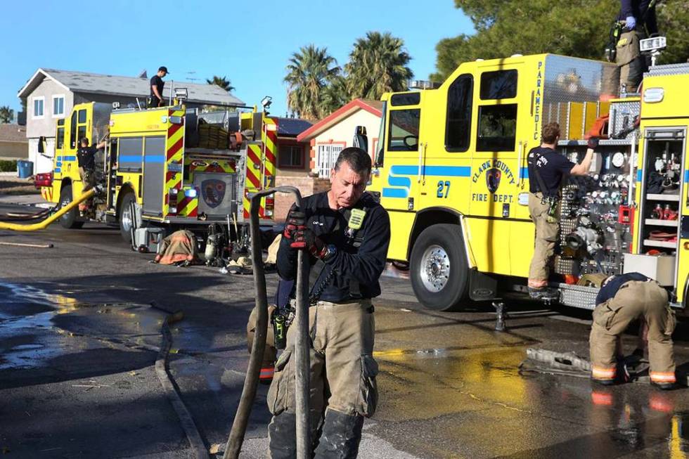 Clark County firefighters prepare to leave after battling a house fire at 4860 Plata del Sol Dr ...