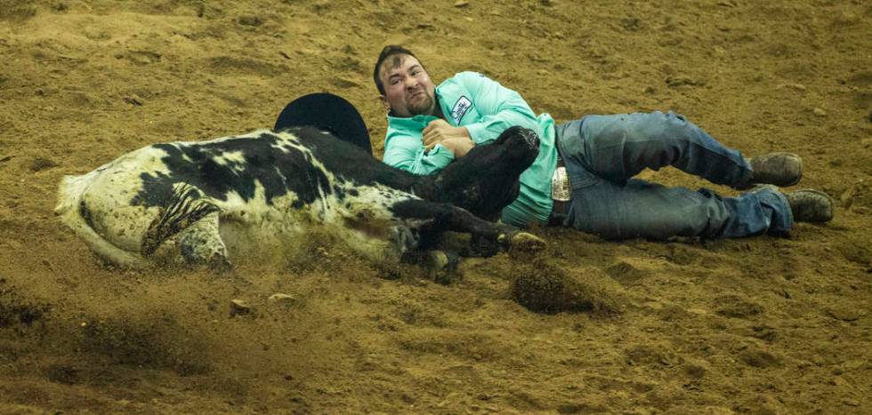 Tanner Brunner of Ramona, Kan., gets down in the dirt for Steer Wrestling during the fourth go ...