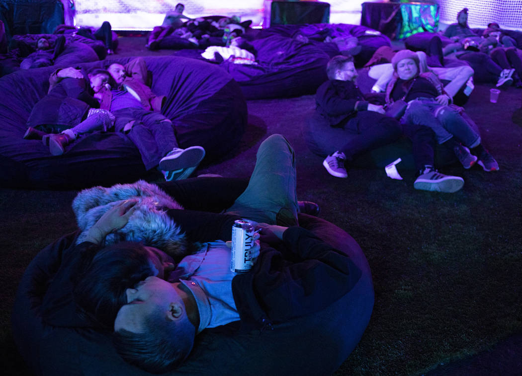 Festival attendees rest in bean bag chairs at Intersect Festival on Friday, Dec. 6, 2019, in La ...