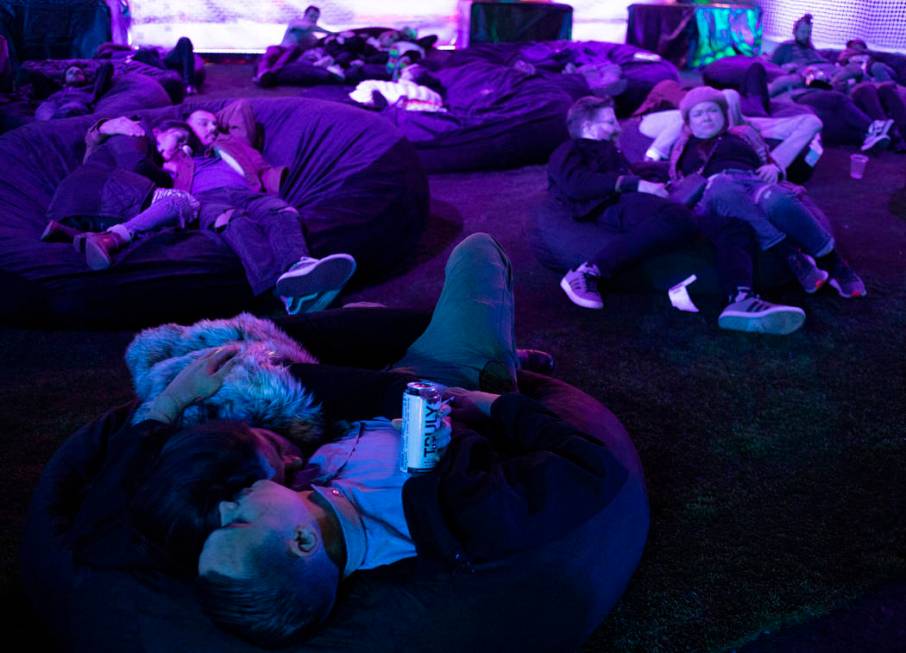 Festival attendees rest in bean bag chairs at Intersect Festival on Friday, Dec. 6, 2019, in La ...