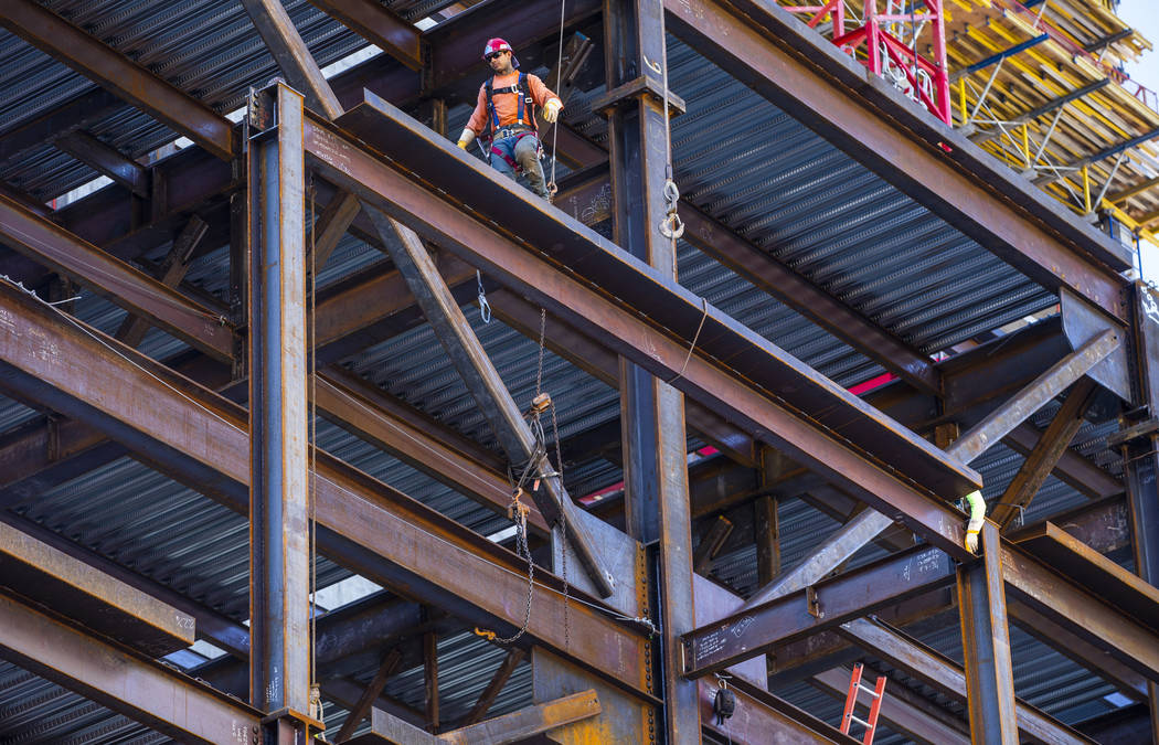Workers secure another beam brought up during a construction tour of the Circa on Monday, Dec. ...