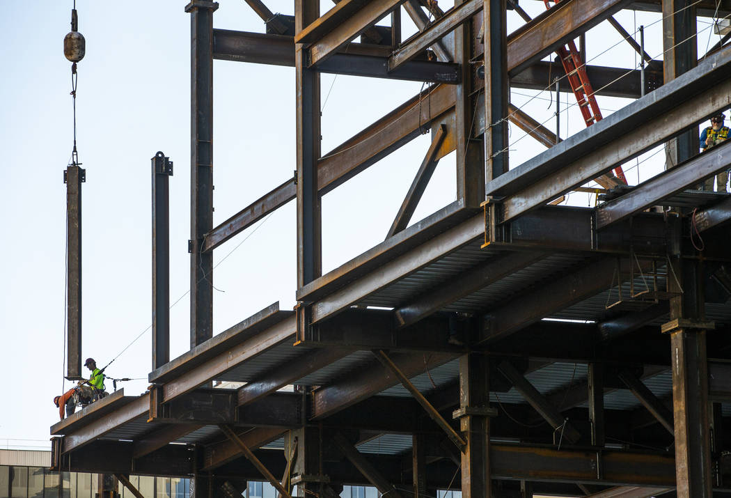 Workers ready to secure another beam being brought up during a construction tour of the Circa o ...