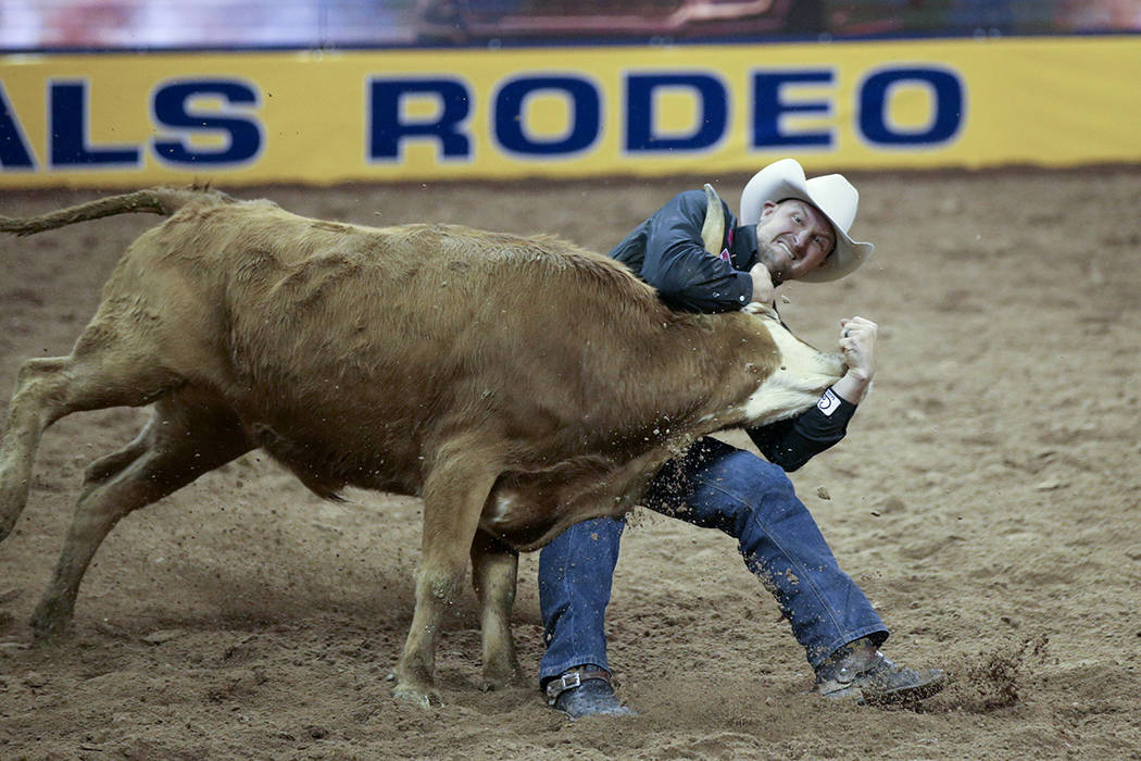 Kyle Irwin of Robertsdale, Ala. competes in Steer Wrestling during Bareback Riding in the fifth ...