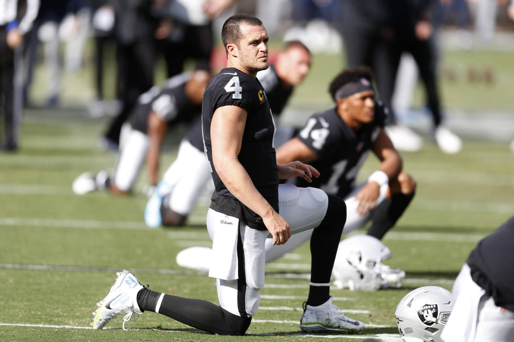 Oakland Raiders quarterback Derek Carr warms up before an NFL football game against the Tenness ...