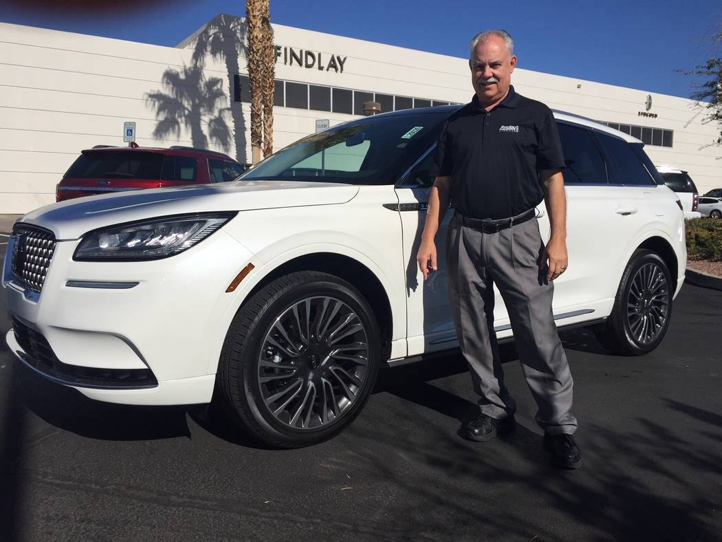 Findlay Lincoln sales consultant Jeff Lamper is seen with a 2020 Lincoln Corsair sport utility ...