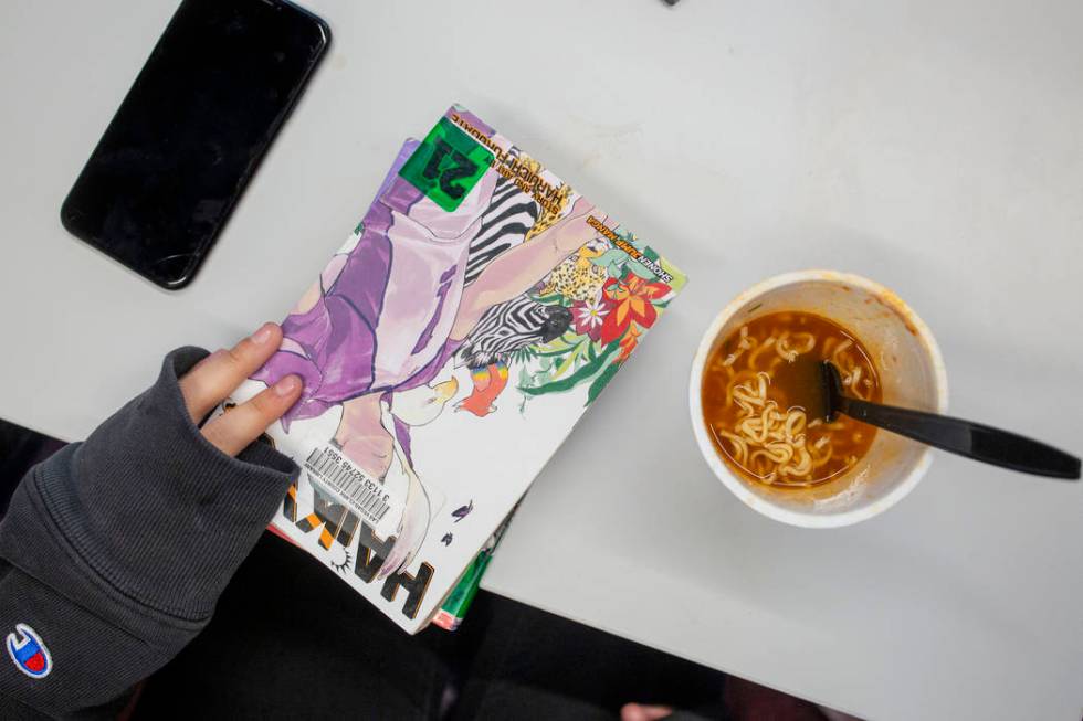 Nicole Valenzuela, 12, holds her stack of anime novels at the East Las Vegas Library in Las Veg ...