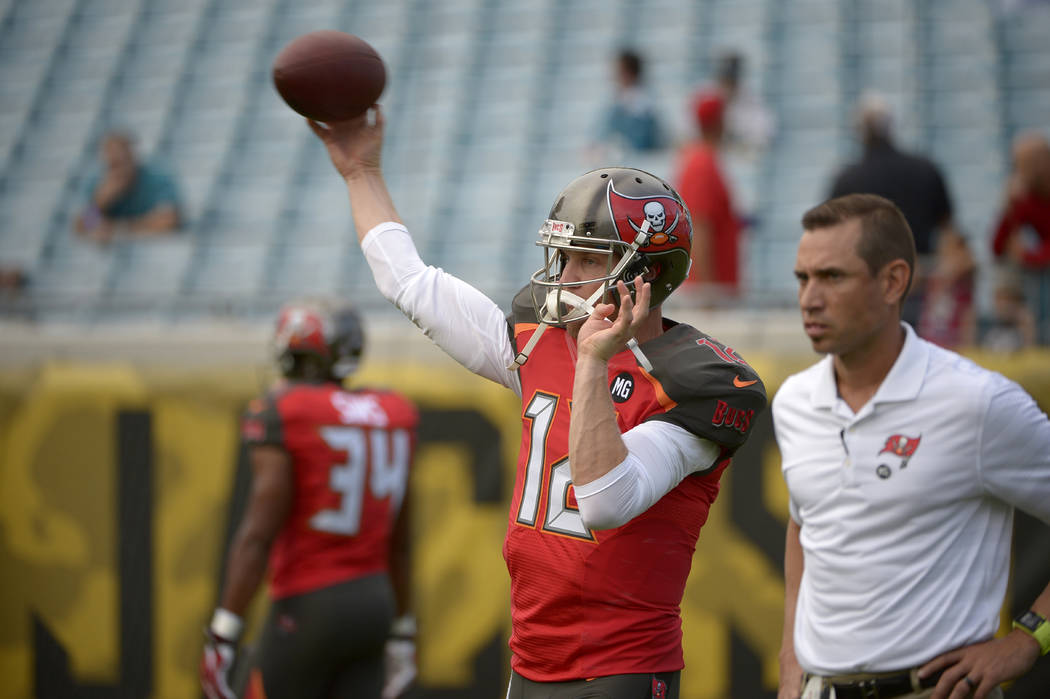 Tampa Bay Buccaneers quarterback Josh McCown (12) warms up as quarterbacks coach Marcus Arroyo, ...