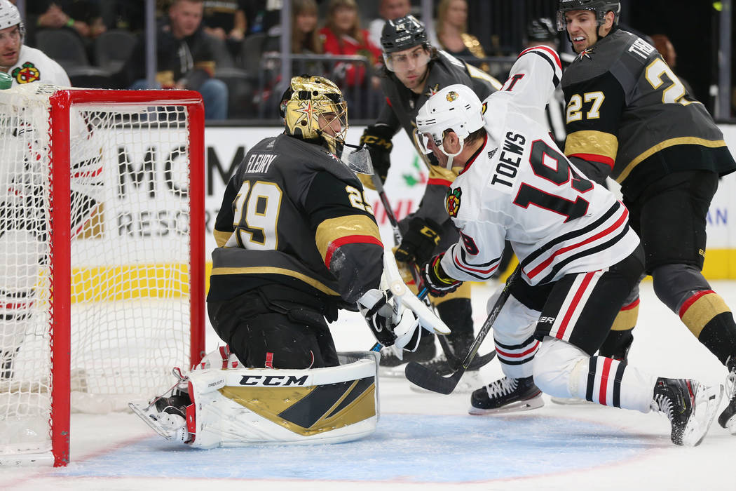 Vegas Golden Knights goaltender Marc-Andre Fleury (29) and defenseman Shea Theodore (27) defend ...