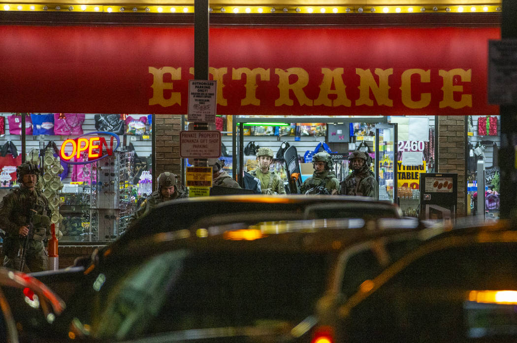 Las Vegas police gather at the store entrance as they work a barricade situation of a woman wit ...