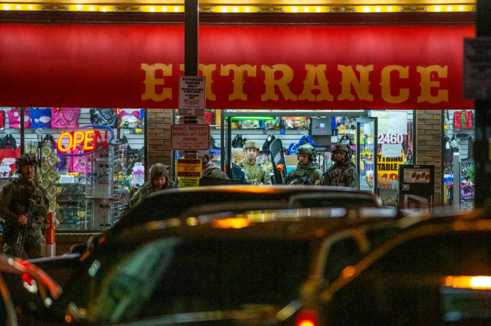 Las Vegas police gather at the store entrance as they work a barricade situation of a woman wit ...