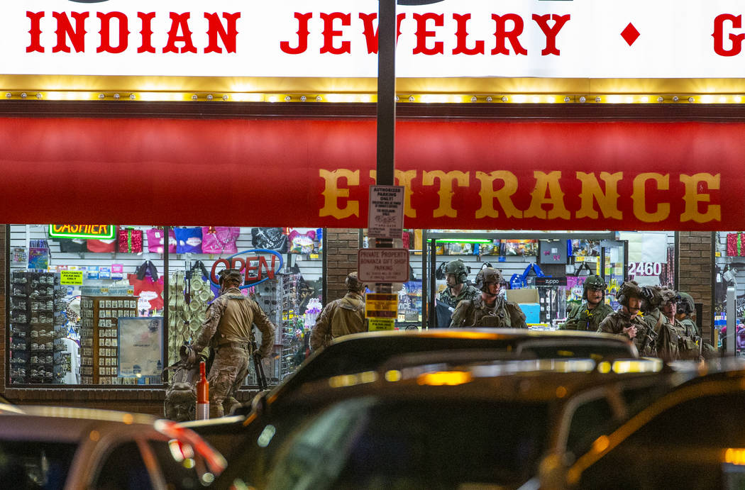 Las Vegas police gather at the store entrance as they work a barricade situation of a woman wit ...