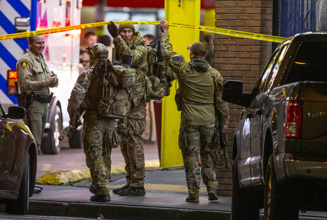 SWAT officers with Las Vegas police arrive in the parking lot as they work a barricade situatio ...