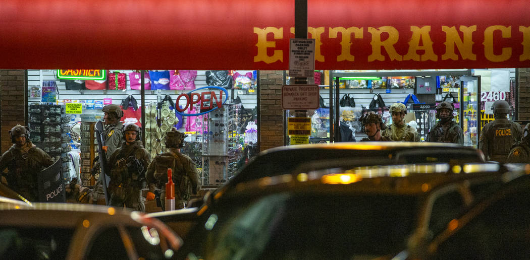 Las Vegas police gather at the store entrance as they work a barricade situation of a woman wit ...