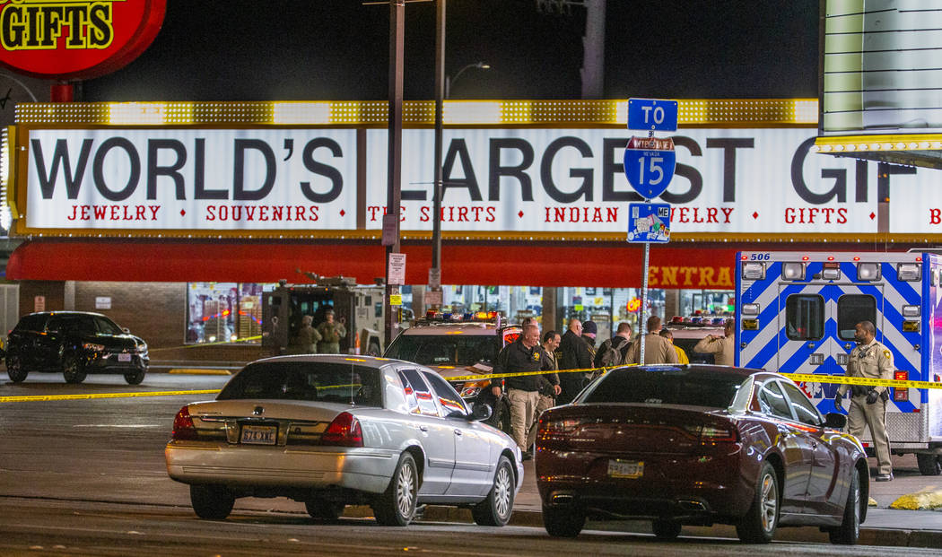 Las Vegas police gather in the parking lot as they work a barricade situation of a woman with a ...