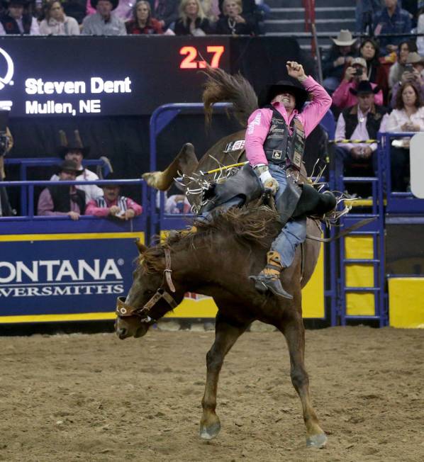 Steven Dent of Mullen, Neb. rides Redzilla during Bareback Riding in the fifth go-around of the ...