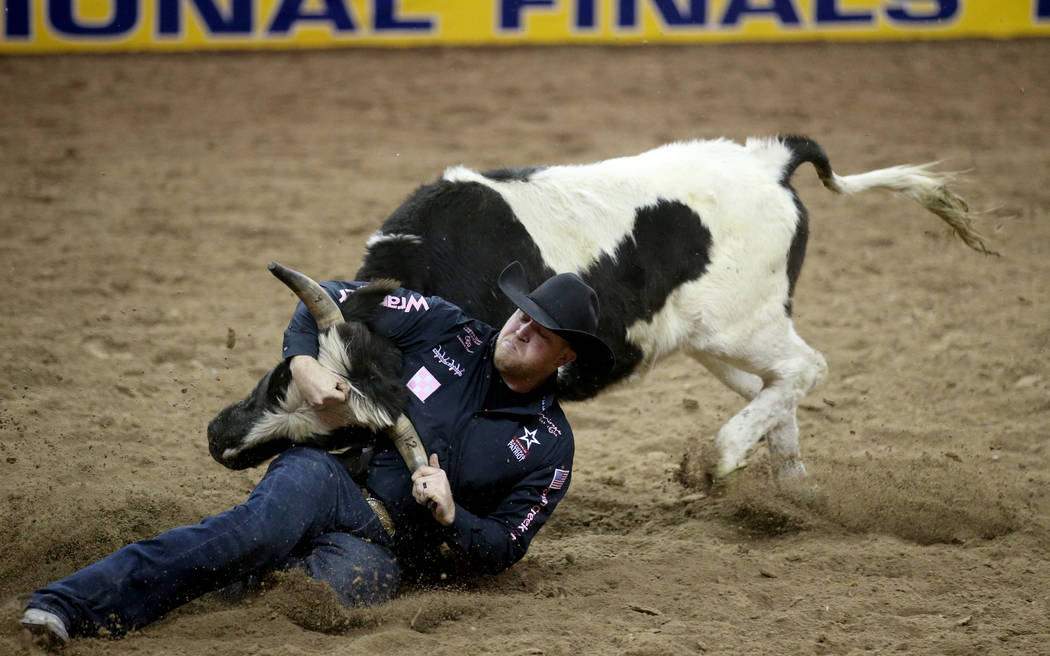 Will Lummus of West Point, Miss. competes in Steer Wrestling during Bareback Riding in the fift ...