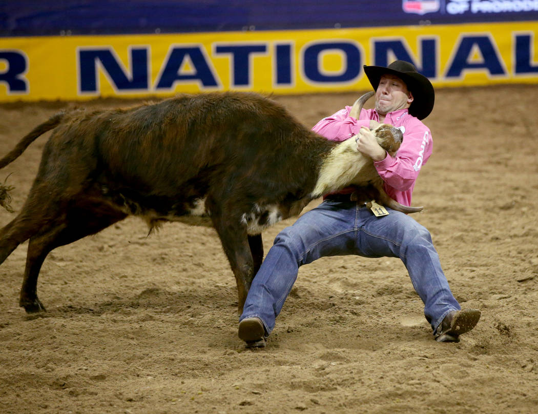 Scott Guenthner of Canada competes in Steer Wrestling during Bareback Riding in the fifth go-ar ...